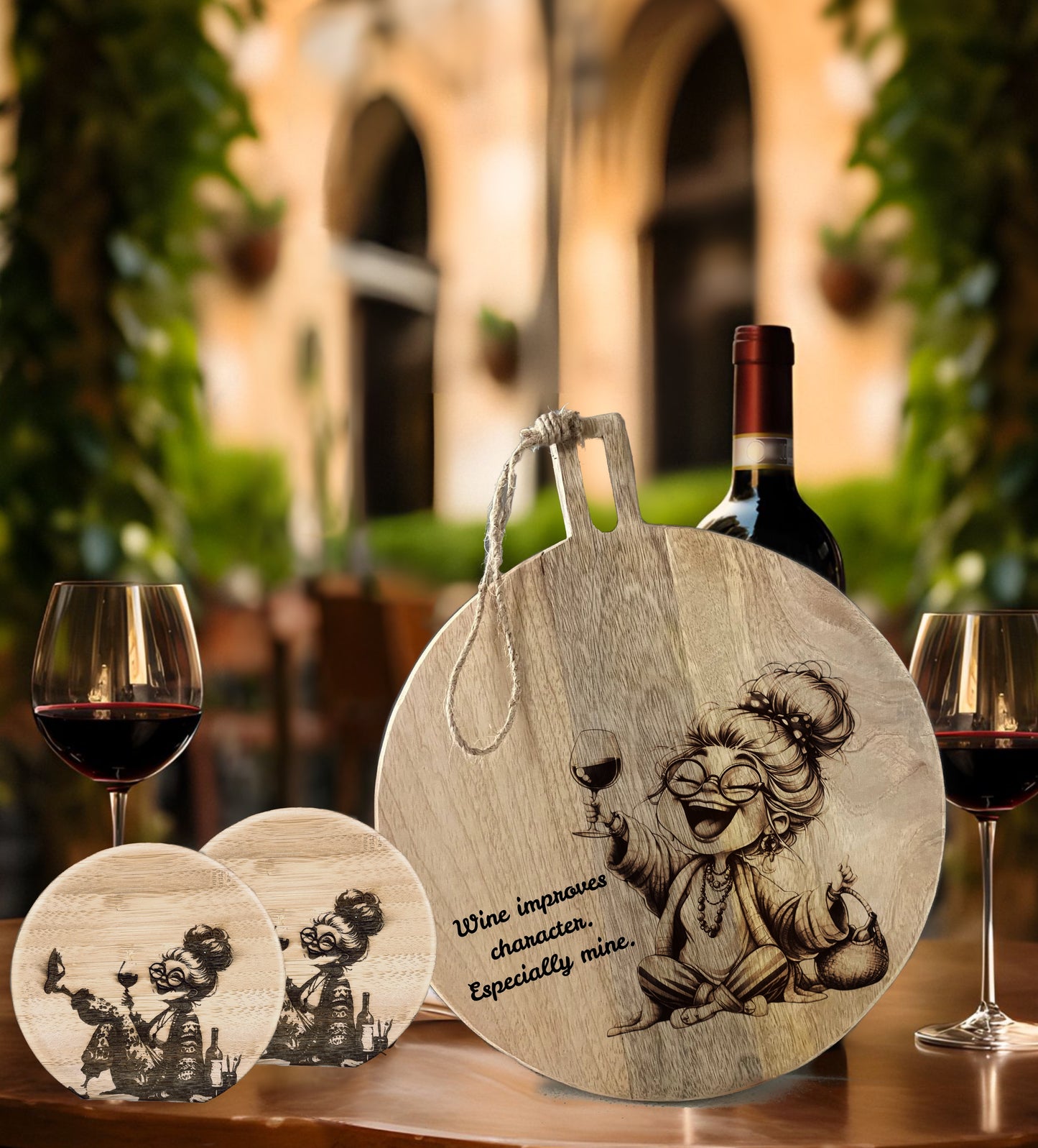 Wooden cutting board with engraved design and text, accompanied by wine glasses and a bottle outdoors.