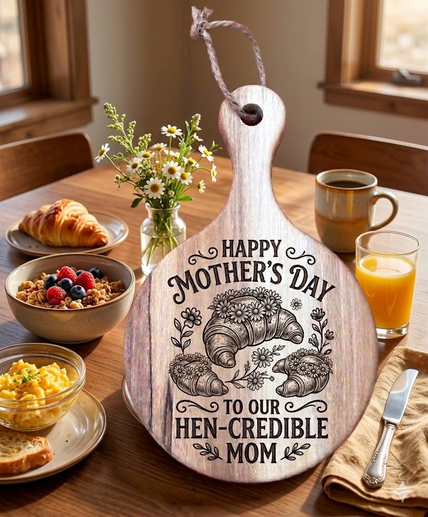 Wooden cutting board with Mother's Day message on a breakfast table